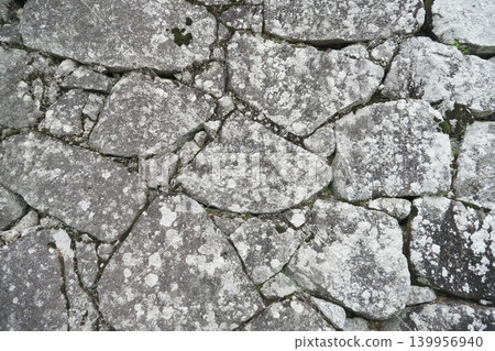 A background with an irregular stonework texture of weathered white stone walls. A background with an irregular stonework texture of weathered white stone walls. 139956940