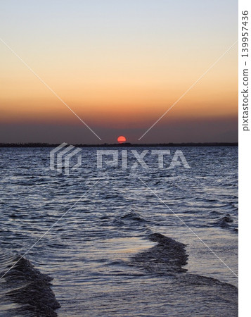 The African sun setting over the sea The African sun setting over the sea 139957436