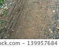 Tire Tracks on Gravel and Dirt Path 139957684