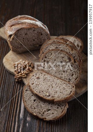 Walnut Bread and Slices on Cutting Board. Walnut Bread and Slices on Cutting Board. 139957917