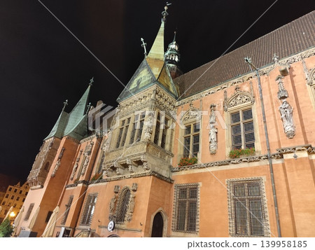 Old Town City Hall Building in Wroclaw Poland with Gothic Architecture Facade and Spires at Night. Market Square Old Town City Hall Building in Wroclaw Poland with Gothic Architecture Facade and Spires at Night. Market Square 139958185