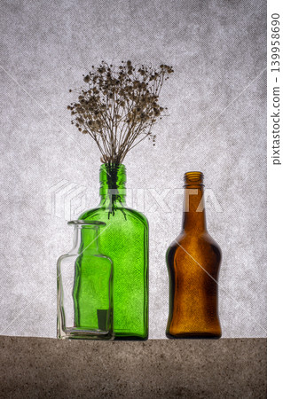 Still life with colored bottles and dried plants Still life with colored bottles and dried plants 139958690