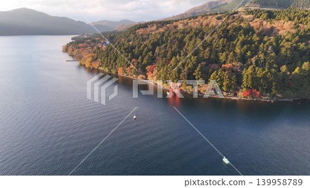Autumn aerial view of Lake Ashi in Hakone and the Peace Torii gate at dusk. Autumn aerial view of Lake Ashi in Hakone and the Peace Torii gate at dusk. 139958789