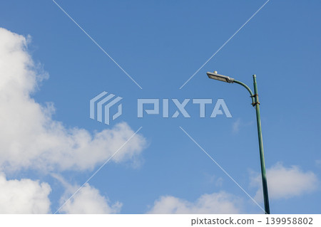 Street Light Against Blue Sky with Clouds. Outdoor at Daytime. Urban City. Lamp Post. Daylight Background. High quality photo Street Light Against Blue Sky with Clouds. Outdoor at Daytime. Urban City. Lamp Post. Daylight Background. High quality photo 139958802