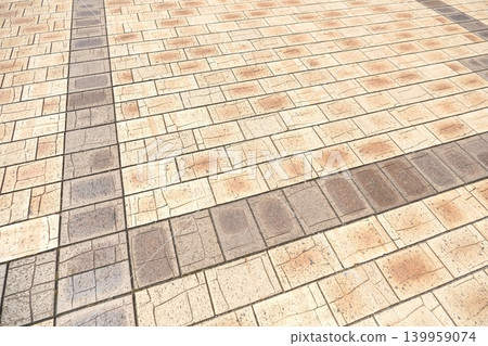 A sidewalk texture background featuring light beige and brown paving tiles. 139959074