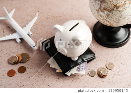 Piggy bank on wallet with globe, savings personal finance international budgeting and travel finance concept Piggy bank on wallet with globe, savings personal finance international budgeting and travel finance concept 139959145