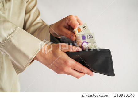 Person taking cash from wallet, personal finance budgeting and household expense management concept Person taking cash from wallet, personal finance budgeting and household expense management concept 139959146