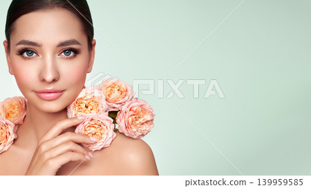 Beautiful young woman with a rose flower 139959585