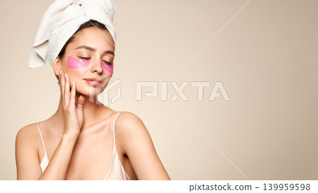 Young woman with cosmetic patches on her eyes Young woman with cosmetic patches on her eyes 139959598