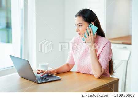 Woman working with laptop computer at home Woman working with laptop computer at home 139959608