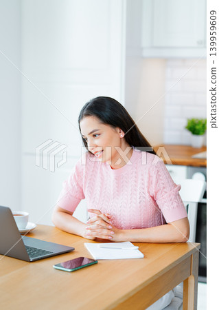 Woman working with laptop computer at home Woman working with laptop computer at home 139959609