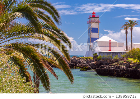 Santa Marta lighthouse and palm trees on Atlantic coast in Cascais Portugal Santa Marta lighthouse and palm trees on Atlantic coast in Cascais Portugal 139959712