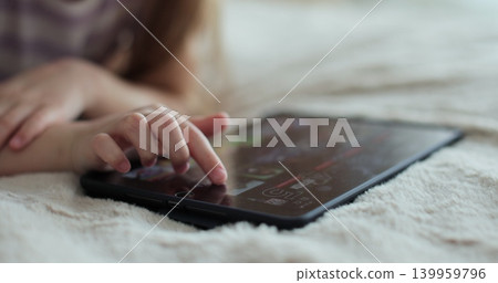 Close-up finger scrolling social media. Girl browsing digital tablet computer. The problem of addiction to gadgets. Close-up finger scrolling social media. Girl browsing digital tablet computer. The problem of addiction to gadgets. 139959796