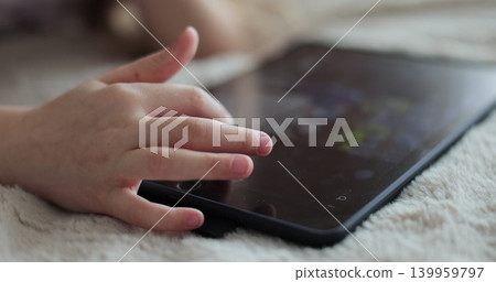 Close-up finger scrolling social media. Girl browsing digital tablet computer. The problem of addiction to gadgets. Close-up finger scrolling social media. Girl browsing digital tablet computer. The problem of addiction to gadgets. 139959797