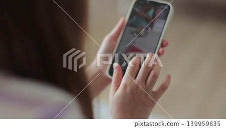 Little girl watching news feed social media smartphone message sitting cozy couch. Digital lifestyle. 139959835