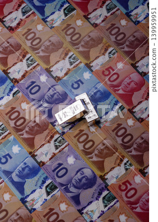 A silver bar, white metal against a backdrop of Canadian money, as a concept. A silver bar A silver bar, white metal against a backdrop of Canadian money, as a concept. A silver bar 139959951