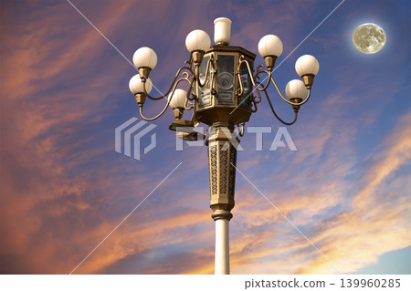 Street lamp on Tiananmen Square in Beijing, China (against the sunset with the super moon), with propaganda or public announcement speakers Street lamp on Tiananmen Square in Beijing, China (against the sunset with the super moon), with propaganda or public announcement speakers 139960285