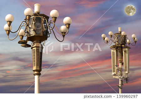 Street lamp on Tiananmen Square in Beijing, China (against the sunset with the super moon), with propaganda or public announcement speakers Street lamp on Tiananmen Square in Beijing, China (against the sunset with the super moon), with propaganda or public announcement speakers 139960297