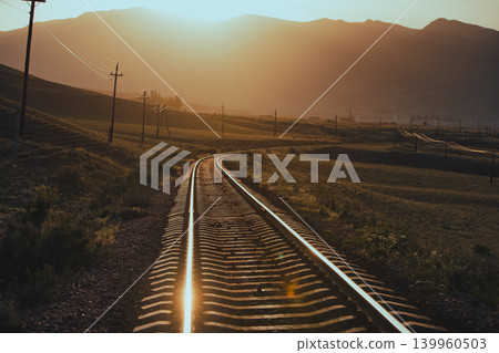 Railroad in the mountains at warm sunset light Railroad in the mountains at warm sunset light 139960503