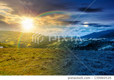day meet night. mountain landscape with field. sun and moon in harmony over trees on the hills and rural valley beneath an epic sky in the background. view of carpathian mountains on summer solstice day meet night. mountain landscape with field. sun and moon in harmony over trees on the hills and rural valley beneath an epic sky in the background. view of carpathian mountains on summer solstice 139960526