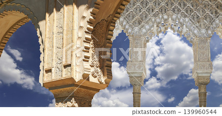 Arches in Islamic (Moorish) style (against the background of a beautiful sky with clouds) in Alhambra, Granada, Spain Arches in Islamic (Moorish) style (against the background of a beautiful sky with clouds) in Alhambra, Granada, Spain 139960544