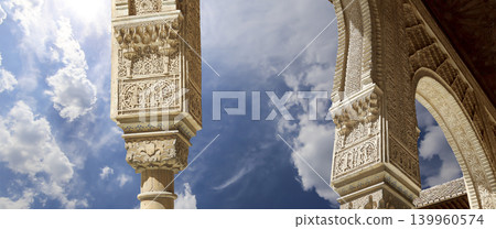 Arches in Islamic (Moorish) style (against the background of a beautiful sky with clouds) in Alhambra, Granada, Spain 139960574
