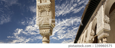 Arches in Islamic (Moorish) style (against the background of a beautiful sky with clouds) in Alhambra, Granada, Spain Arches in Islamic (Moorish) style (against the background of a beautiful sky with clouds) in Alhambra, Granada, Spain 139960575