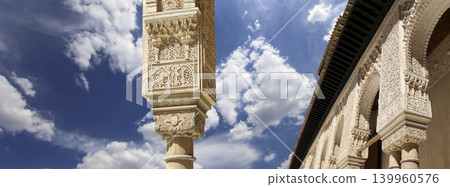 Arches in Islamic (Moorish) style (against the background of a beautiful sky with clouds) in Alhambra, Granada, Spain Arches in Islamic (Moorish) style (against the background of a beautiful sky with clouds) in Alhambra, Granada, Spain 139960576