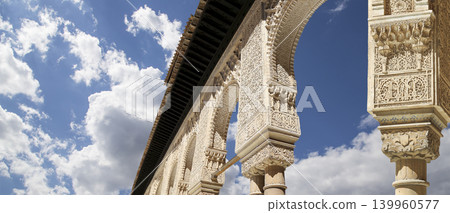 Arches in Islamic (Moorish) style (against the background of a beautiful sky with clouds) in Alhambra, Granada, Spain 139960577