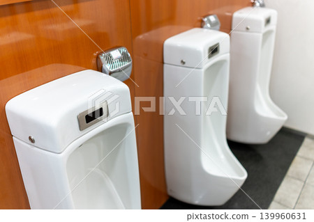 Clean and tidy men's restroom facilities in a commercial building Clean and tidy men's restroom facilities in a commercial building 139960631
