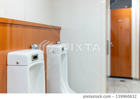 Clean and tidy men's restroom facilities in a commercial building Clean and tidy men's restroom facilities in a commercial building 139960632