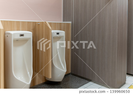 Clean and tidy men's restroom facilities in a commercial building Clean and tidy men's restroom facilities in a commercial building 139960650