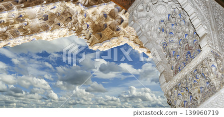 Arches in Islamic (Moorish) style (against the background of a beautiful sky with clouds) in Alhambra, Granada, Spain Arches in Islamic (Moorish) style (against the background of a beautiful sky with clouds) in Alhambra, Granada, Spain 139960719