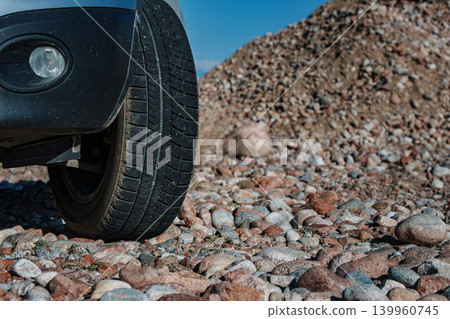 Car wheel on stones close-up view Car wheel on stones close-up view 139960745