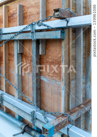 Close-up of wooden formwork and metal scaffolding at a construction site Close-up of wooden formwork and metal scaffolding at a construction site 139961086