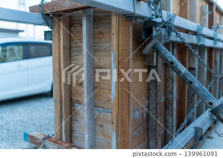 Close-up of wooden formwork and metal scaffolding at a construction site Close-up of wooden formwork and metal scaffolding at a construction site 139961091