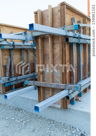 Close-up of wooden formwork and metal scaffolding at a construction site Close-up of wooden formwork and metal scaffolding at a construction site 139961101