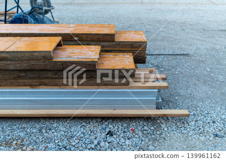 Photographs of lumber and formwork materials piled up at a construction site. Photographs of lumber and formwork materials piled up at a construction site. 139961162