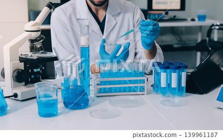 Lab technician experimenting in lab 139961187