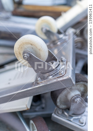 Close-up of old carts and wheels gathered in a materials storage area. Close-up of old carts and wheels gathered in a materials storage area. 139961411
