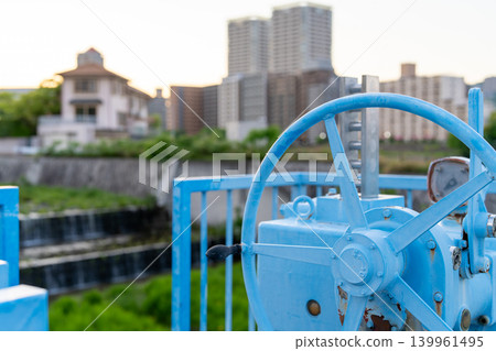 Blue sluice gate operating handle installed along the river 139961495