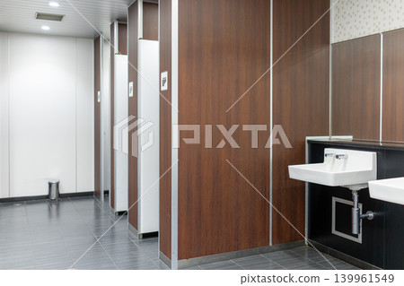 Men's restroom in a commercial facility with striking wood-grain panels. Men's restroom in a commercial facility with striking wood-grain panels. 139961549