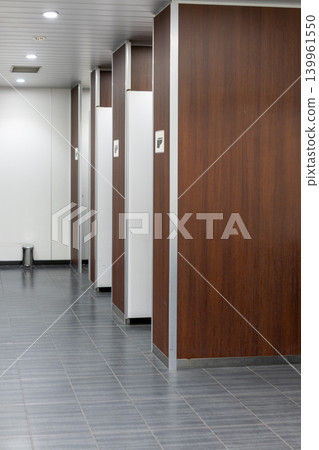 Men's restroom in a commercial facility with striking wood-grain panels. Men's restroom in a commercial facility with striking wood-grain panels. 139961550