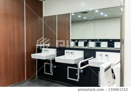 Men's restroom in a commercial facility with striking wood-grain panels. Men's restroom in a commercial facility with striking wood-grain panels. 139961552