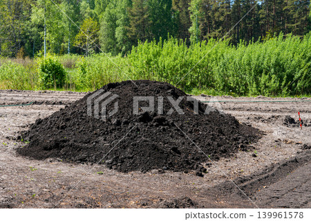 Large pile of fertile black soil on cleared farmland during agricultural site preparation work Large pile of fertile black soil on cleared farmland during agricultural site preparation work 139961578