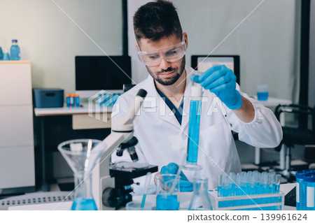 Lab technician experimenting in lab Lab technician experimenting in lab 139961624
