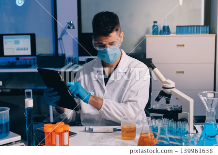 Lab technician experimenting in lab Lab technician experimenting in lab 139961638
