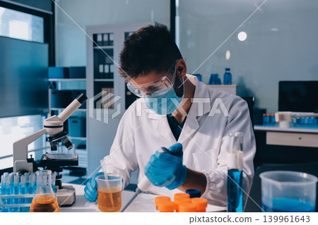 Lab technician experimenting in lab Lab technician experimenting in lab 139961643