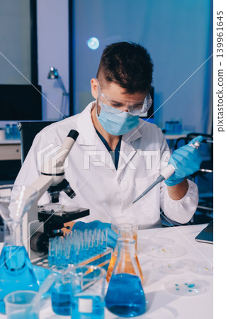 Lab technician experimenting in lab Lab technician experimenting in lab 139961645