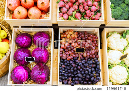 Colorful fruits vegetables are neatly arranged in wooden crates at an outdoor farm local market Colorful fruits vegetables are neatly arranged in wooden crates at an outdoor farm local market 139961746